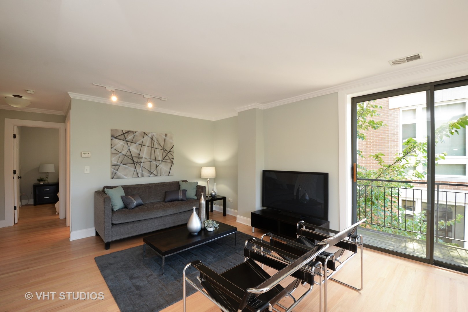 4144 North Sheridan Road, Unit 311 Chicago, IL 60613 - Photo 2 of 10 a living room with furniture and a flat screen tv