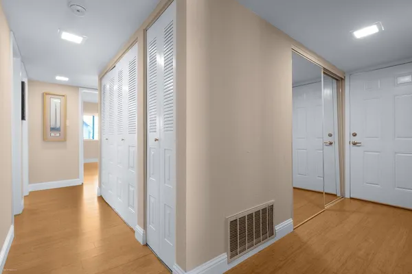 a view of hallway with wooden floor