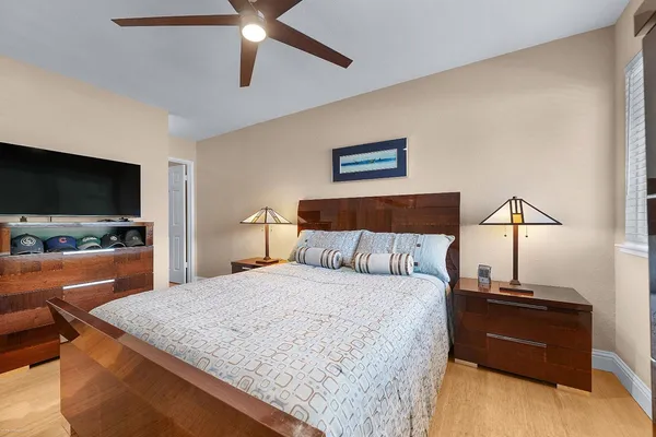 a bedroom with a bed and a flat screen tv