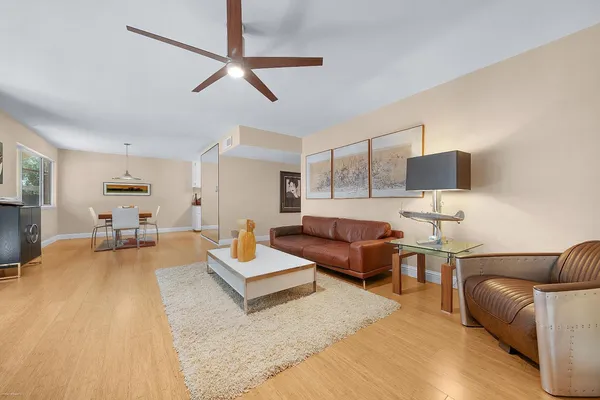 a living room with furniture and a wooden floor