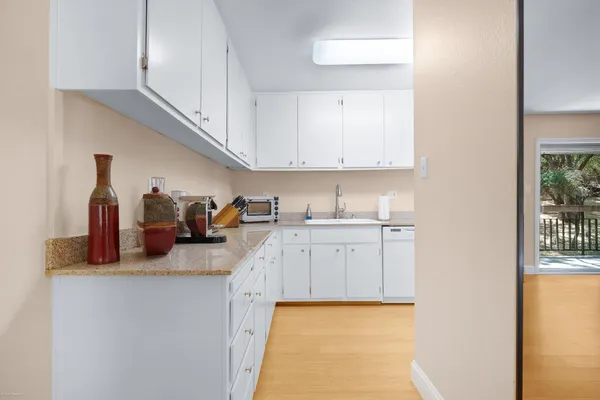 a kitchen with sink and cabinets
