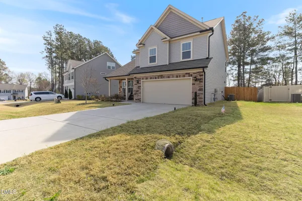a view of a house with a yard and garage