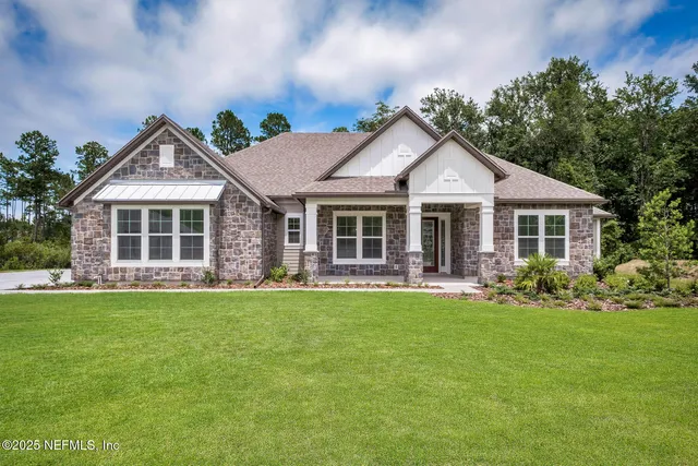 a front view of a house with a garden and porch