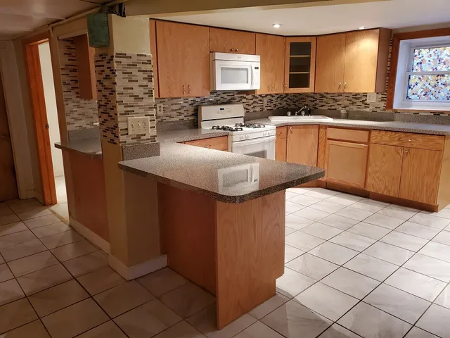 a kitchen with stainless steel appliances granite countertop a stove and a sink