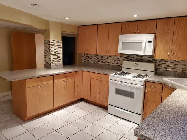 a view of kitchen with furniture and a refrigerator
