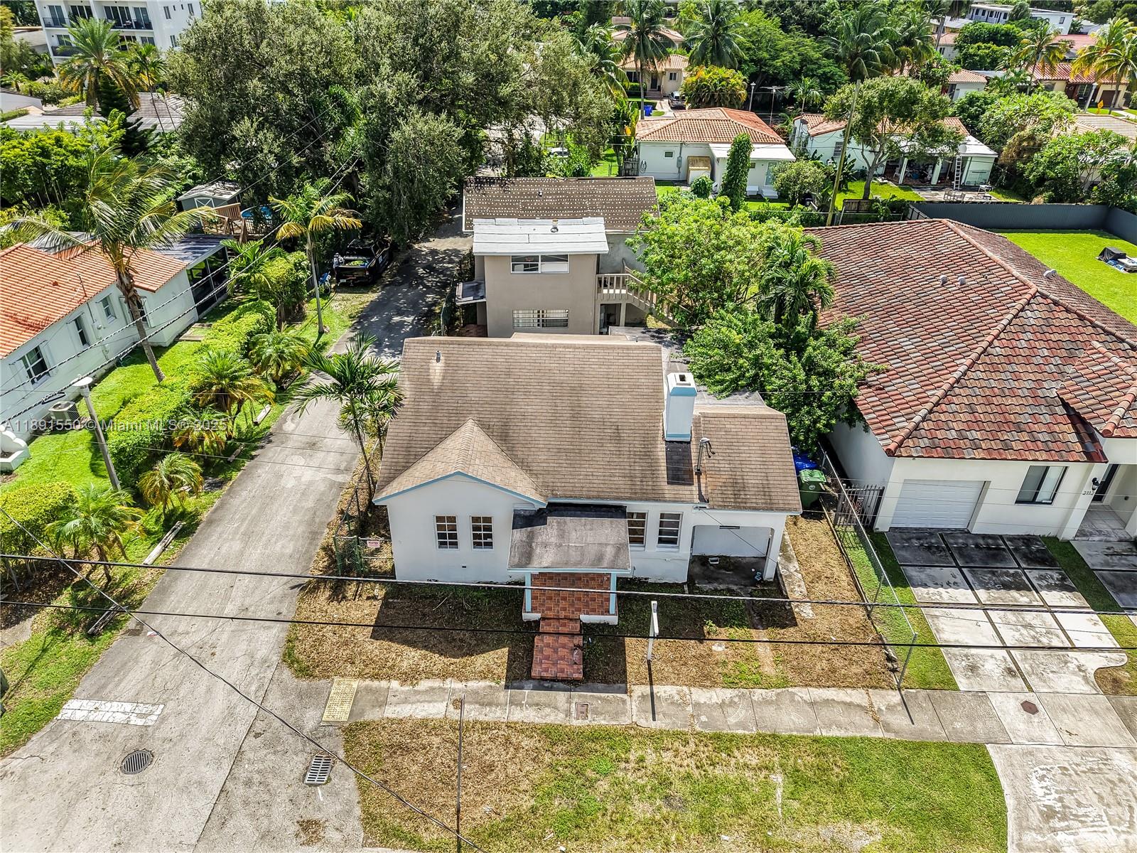 2100 Southwest 25th Street Miami, FL 33133 - Photo 4 of 23 an aerial view of a house with swimming pool and large trees