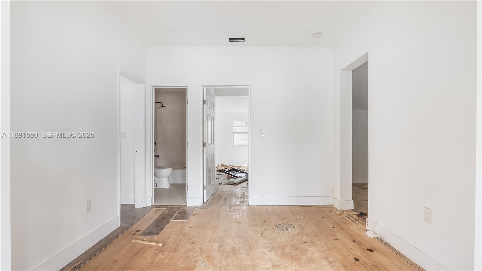 2100 Southwest 25th Street Miami, FL 33133 - Photo 9 of 23 a view of a livingroom with wooden floor and a bathroom