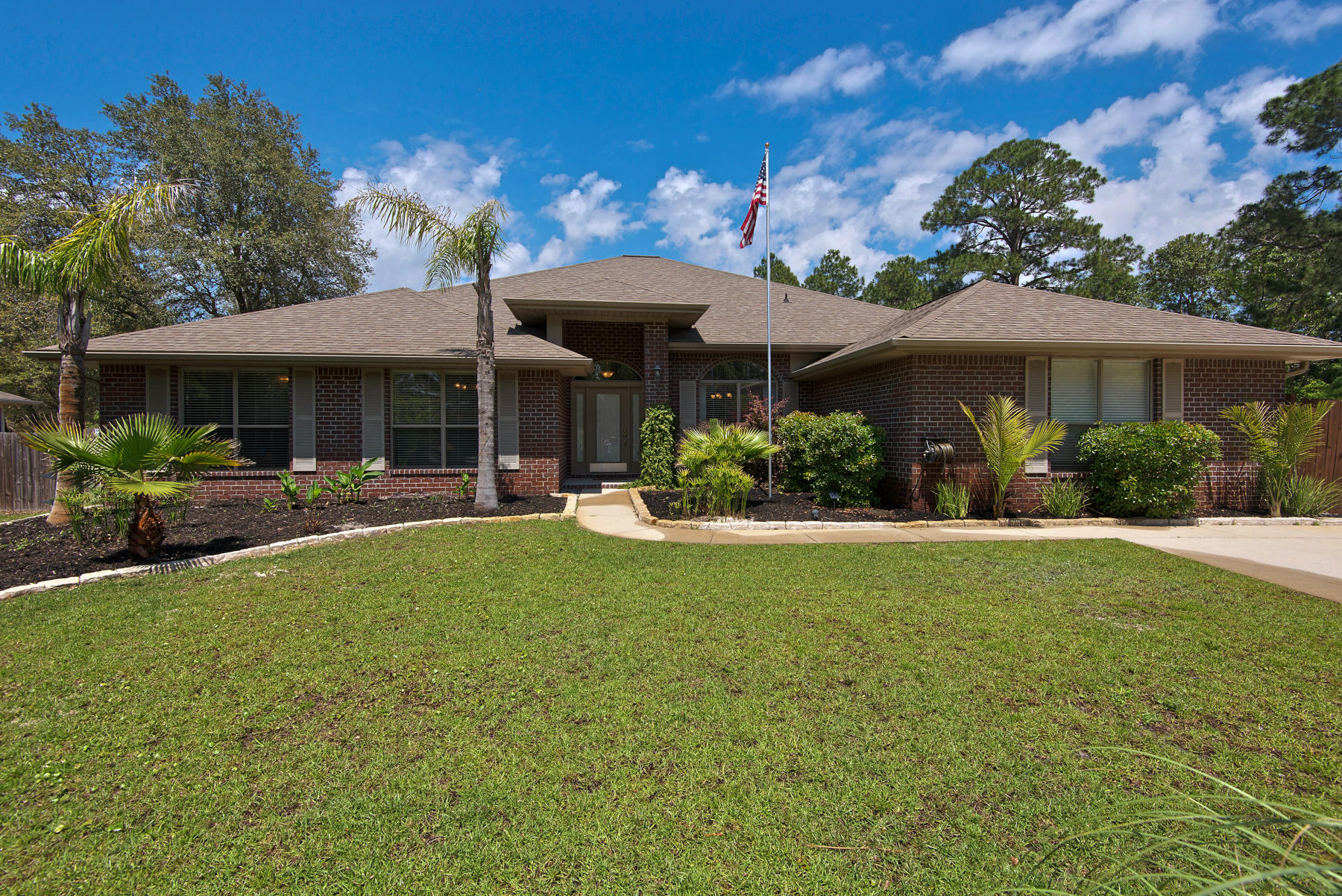 2383 Crescent Road Navarre, FL 32566 - Photo 1 of 48 a view of a house with a yard patio and furniture