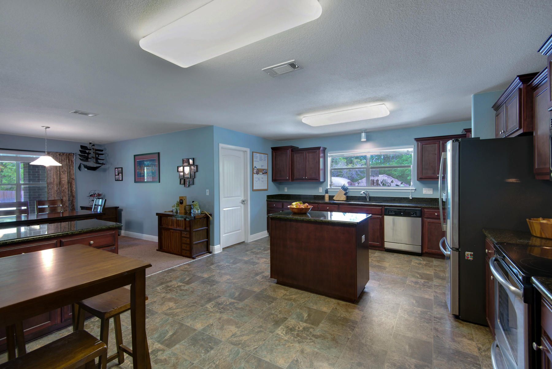 2383 Crescent Road Navarre, FL 32566 - Photo 15 of 48 a kitchen with stainless steel appliances kitchen island granite countertop a refrigerator and a stove top oven
