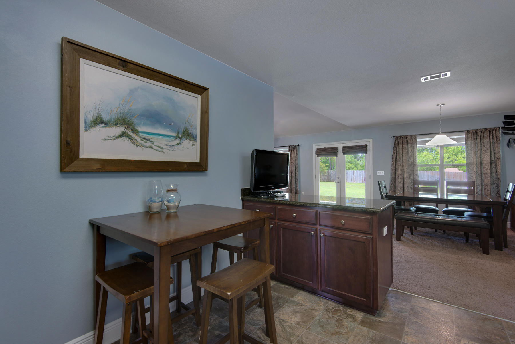 2383 Crescent Road Navarre, FL 32566 - Photo 16 of 48 a kitchen with a table and chairs in it