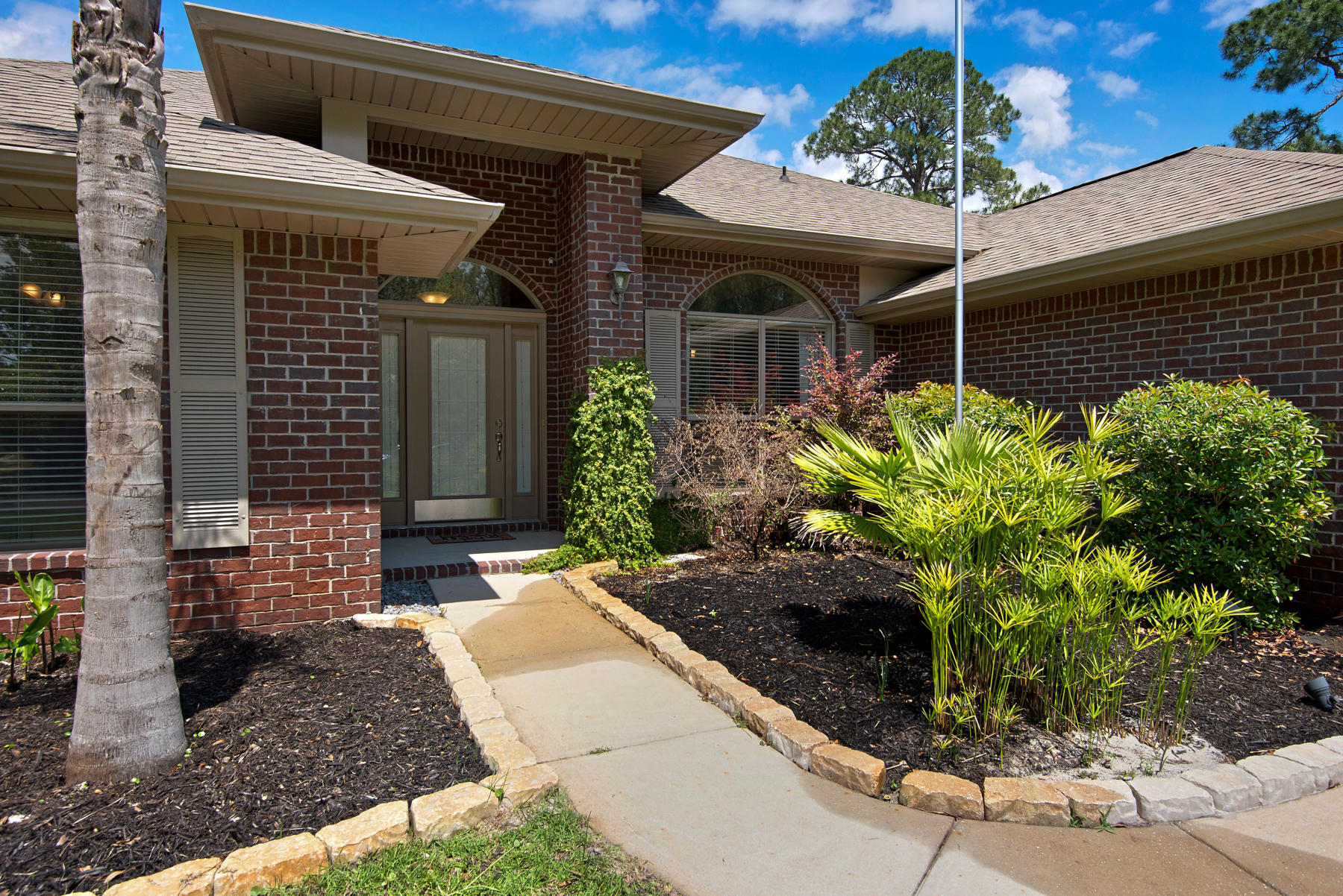 2383 Crescent Road Navarre, FL 32566 - Photo 2 of 48 a front view of a house with garden