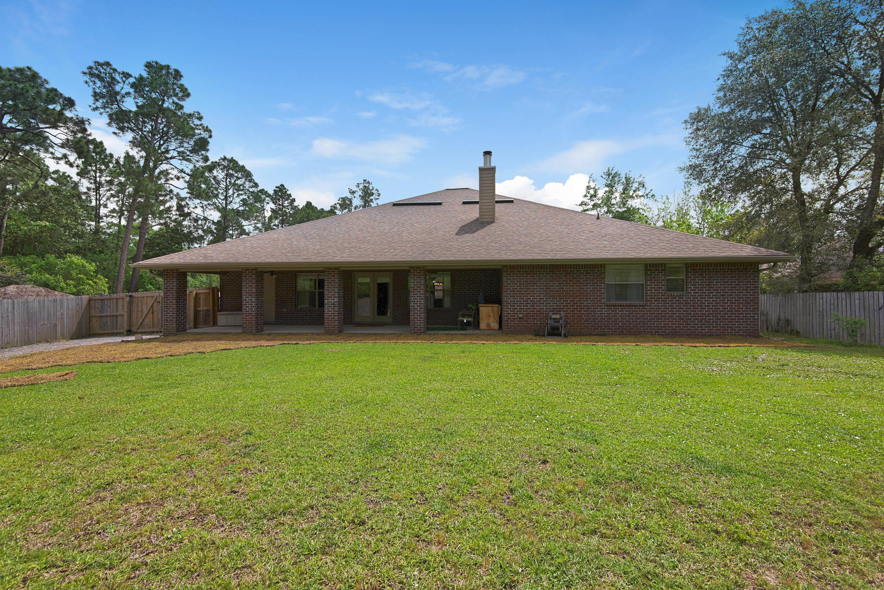 2383 Crescent Road Navarre, FL 32566 - Photo 27 of 48 a front view of a house with a garden