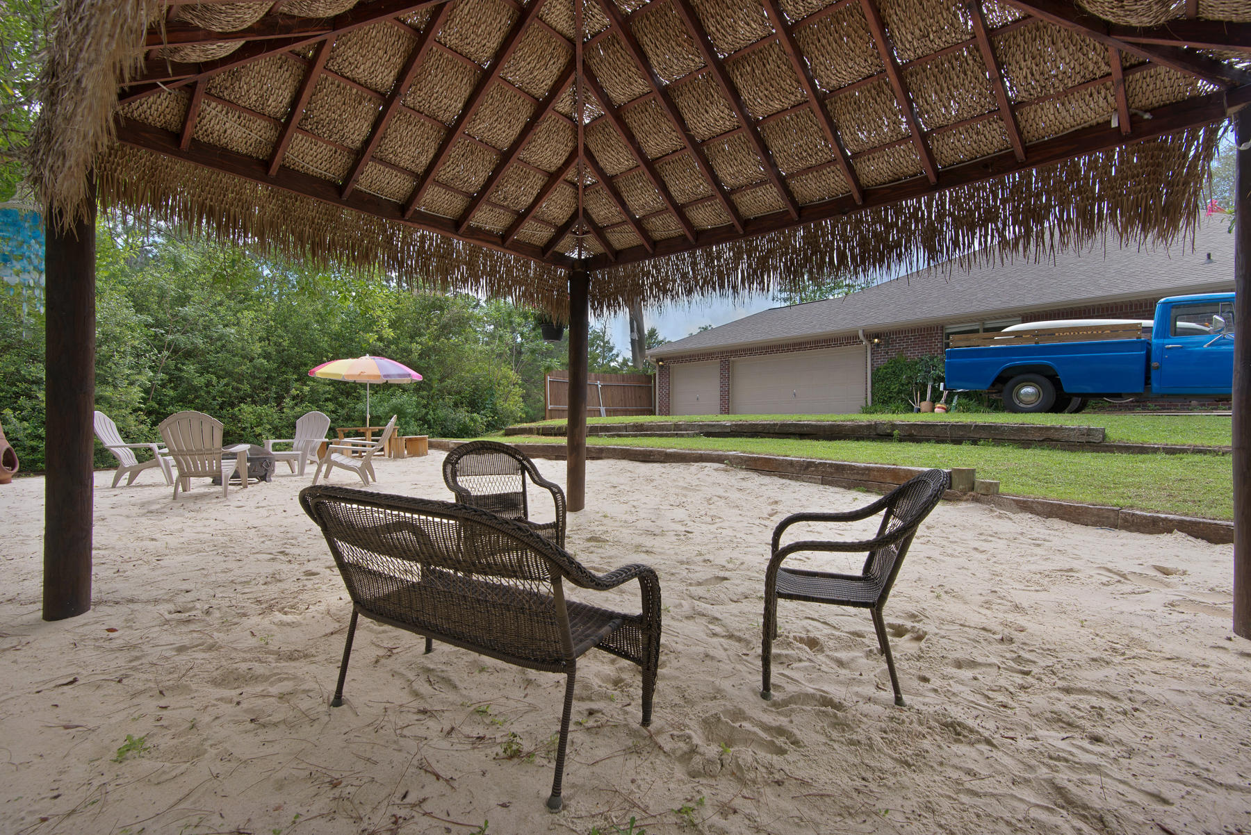 2383 Crescent Road Navarre, FL 32566 - Photo 31 of 48 a view of a backyard with table and chairs with a barbeque grill and couches