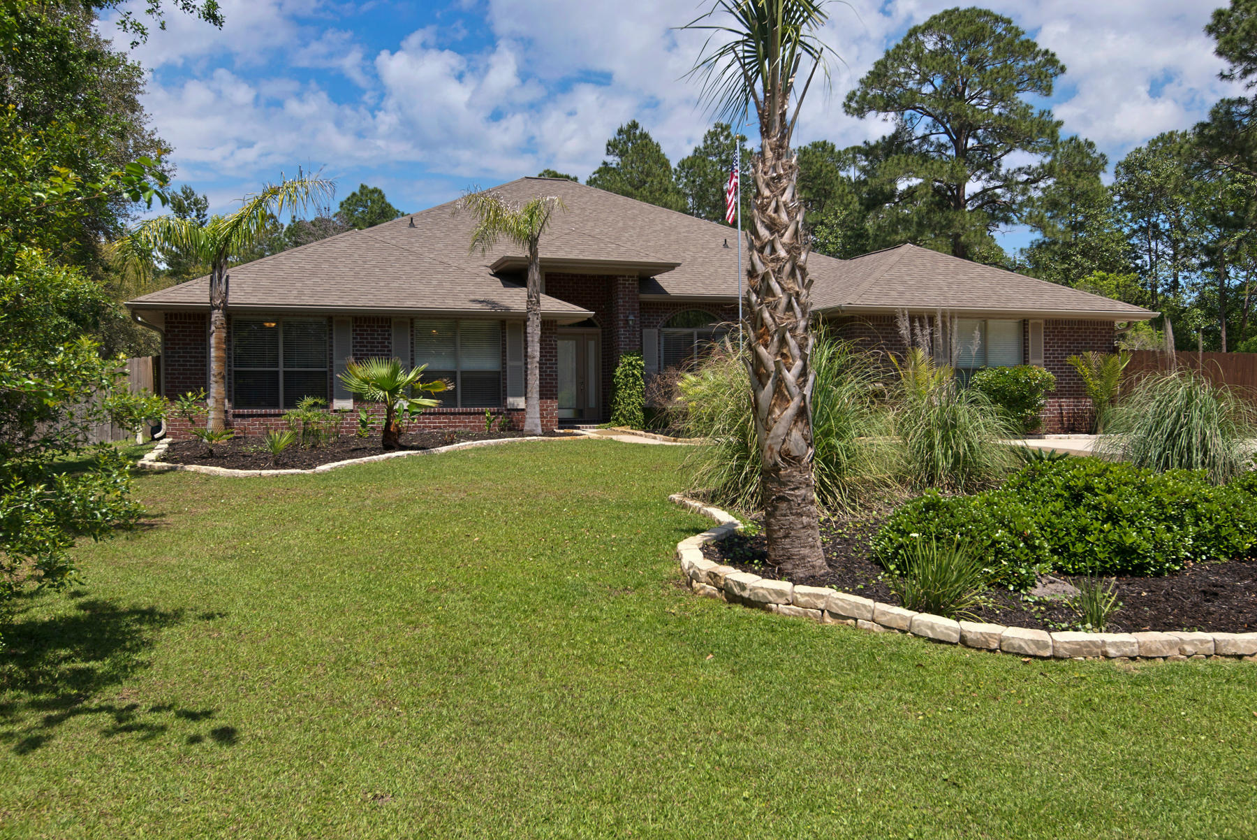 2383 Crescent Road Navarre, FL 32566 - Photo 33 of 48 a front view of a house with garden
