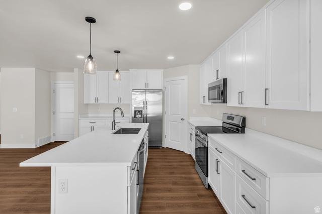 576 7th Avenue Midvale, UT 84047 - Photo 7 of 32 Kitchen featuring stainless steel appliances, white cabinets, pendant lighting, and a center island with sink