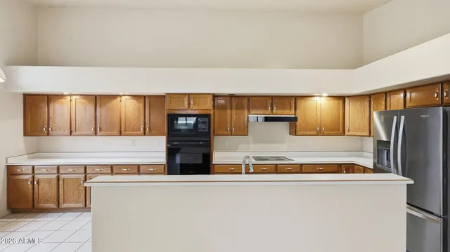 a view of a livingroom with a ceiling fan window and wooden floor