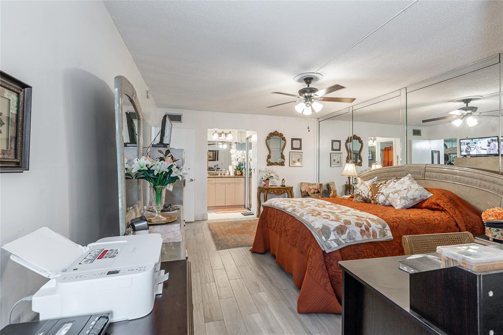 3601 Inverrary Drive, Unit 107 Lauderhill, FL 33319 - Photo 11 of 25 a bedroom with a bed and ceiling fan