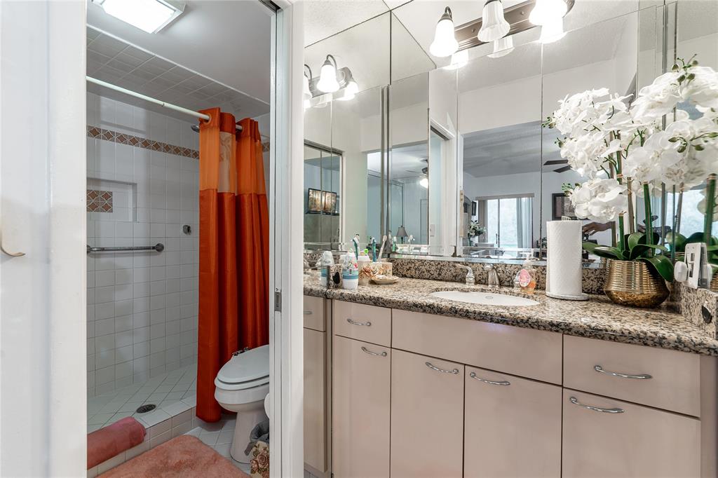 3601 Inverrary Drive, Unit 107 Lauderhill, FL 33319 - Photo 12 of 25 a bathroom with a granite countertop sink a toilet and shower