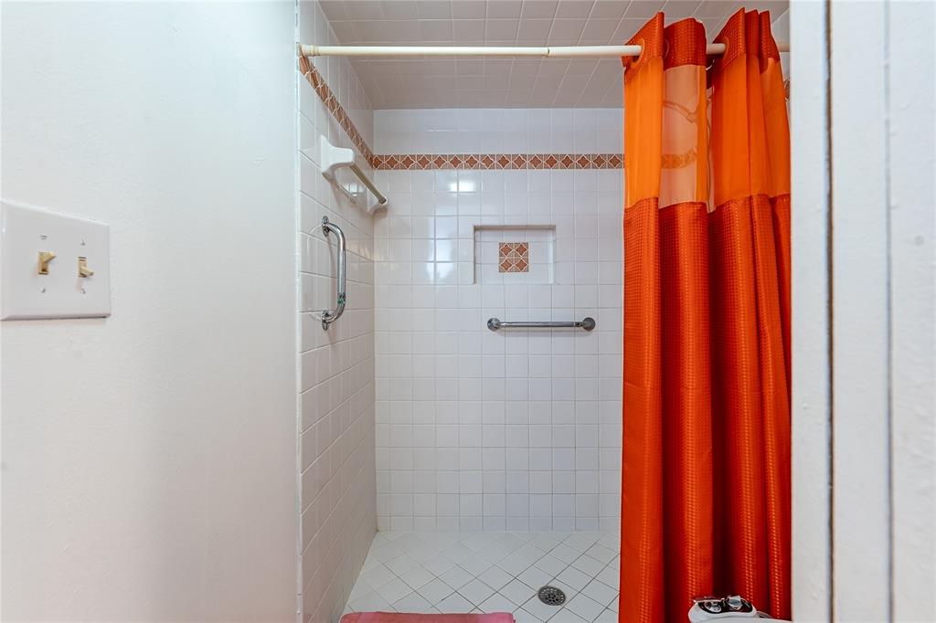 3601 Inverrary Drive, Unit 107 Lauderhill, FL 33319 - Photo 13 of 25 a view of a bathroom with a shower and a curtain
