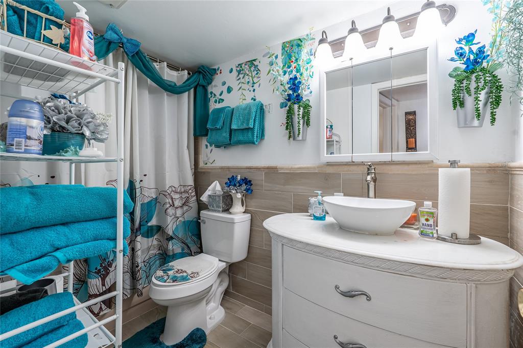 3601 Inverrary Drive, Unit 107 Lauderhill, FL 33319 - Photo 15 of 25 a bathroom with a toilet sink and mirror