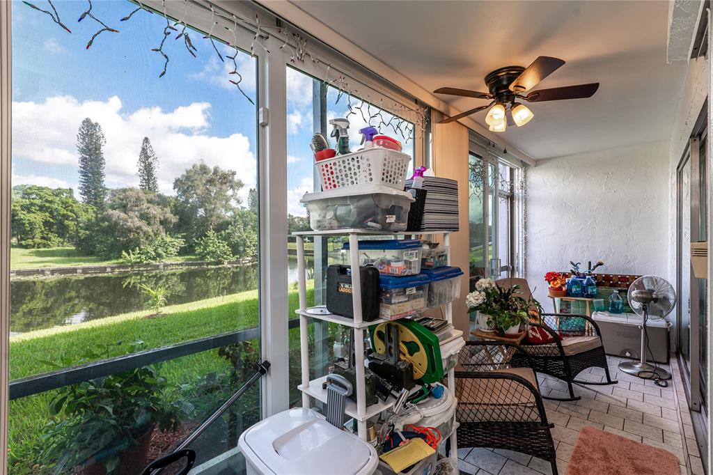 3601 Inverrary Drive, Unit 107 Lauderhill, FL 33319 - Photo 17 of 25 a view of a chairs and table in patio with a lake view