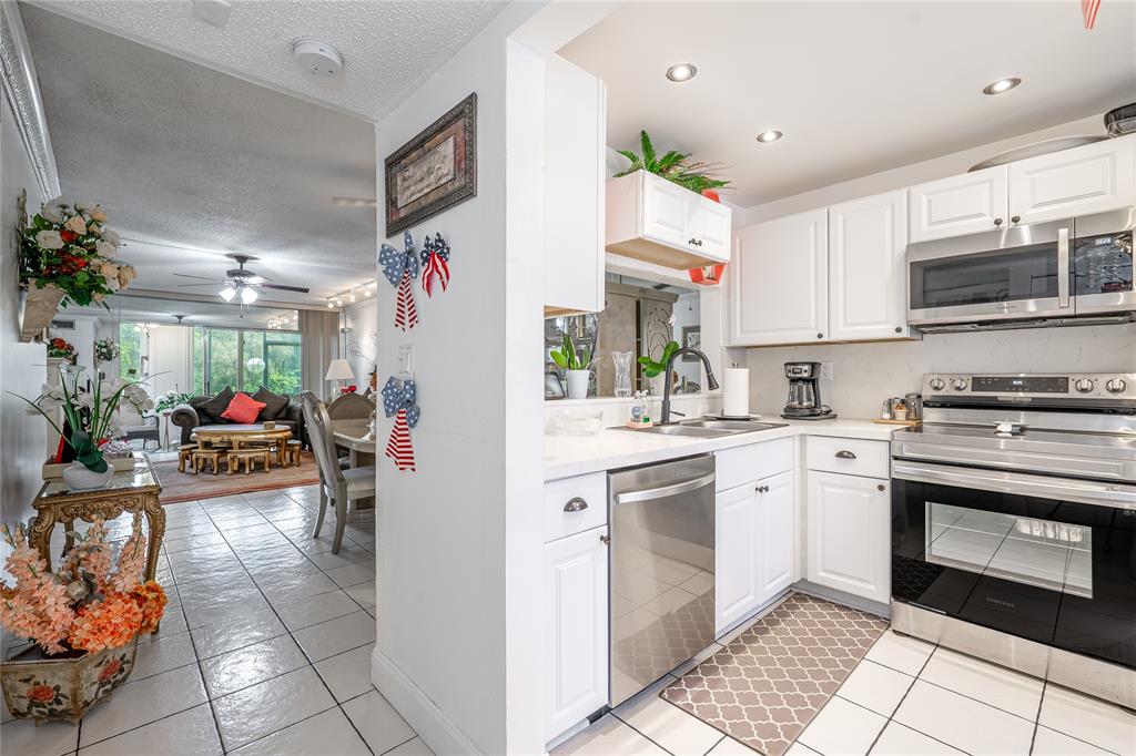 3601 Inverrary Drive, Unit 107 Lauderhill, FL 33319 - Photo 4 of 25 a kitchen with a sink cabinets and window