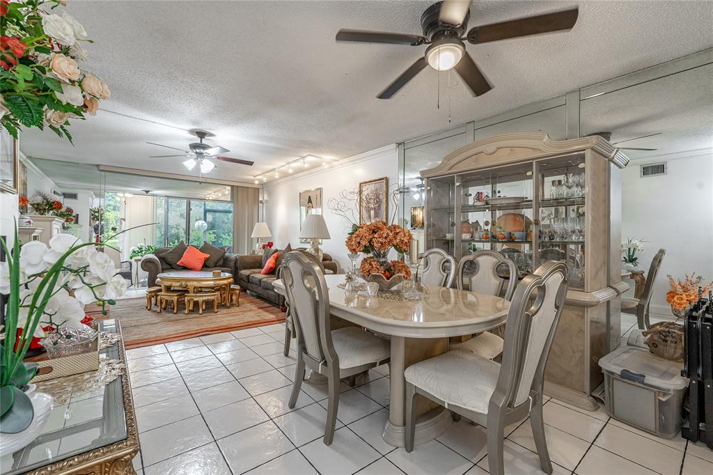 3601 Inverrary Drive, Unit 107 Lauderhill, FL 33319 - Photo 5 of 25 a view of a dining room with furniture and a chandelier
