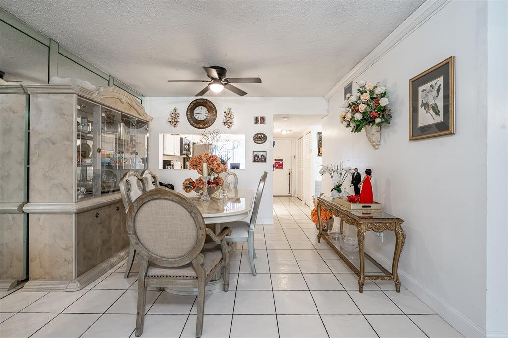 3601 Inverrary Drive, Unit 107 Lauderhill, FL 33319 - Photo 6 of 25 a view of a dining room and kitchen has a table and chairs