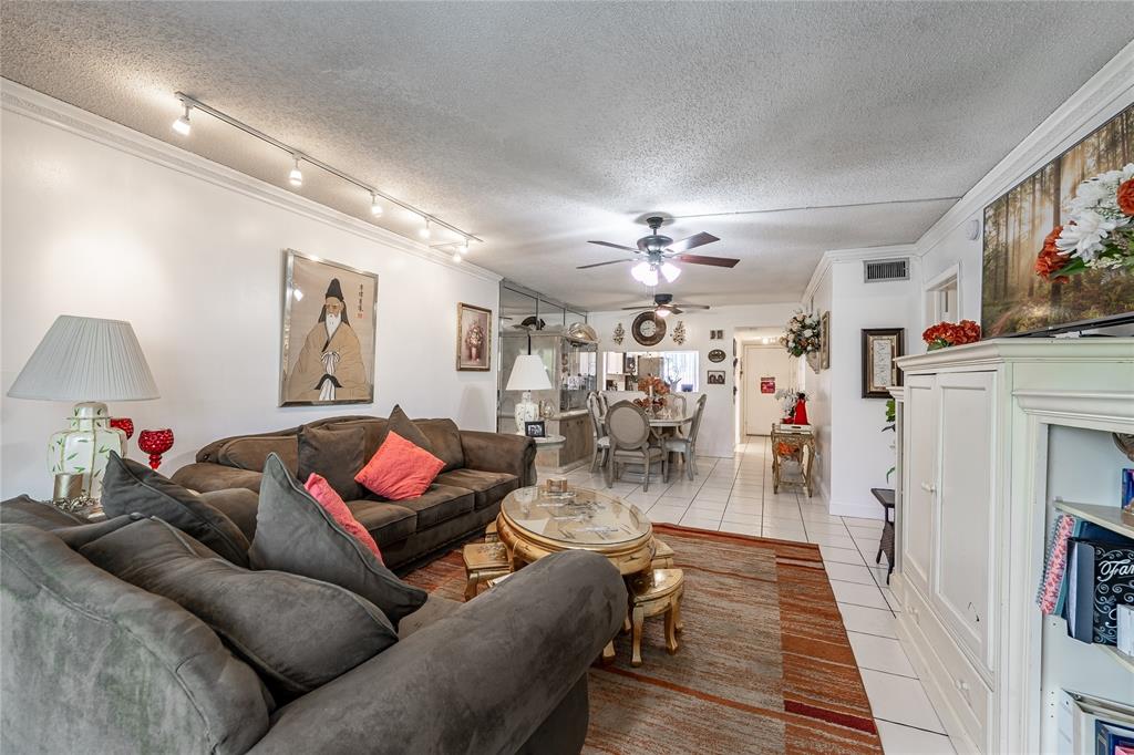 3601 Inverrary Drive, Unit 107 Lauderhill, FL 33319 - Photo 7 of 25 a living room with furniture and wooden floor