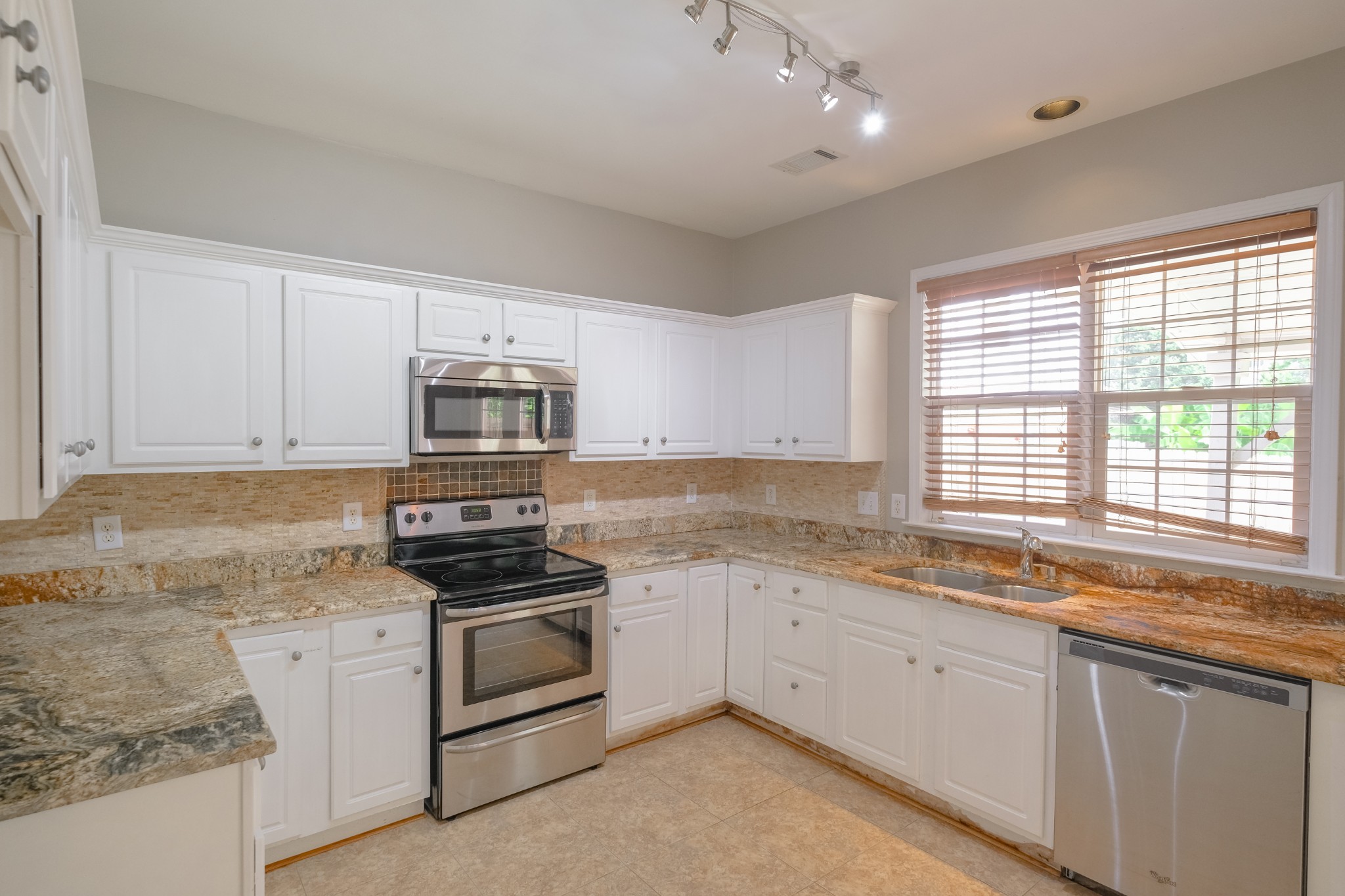 130 Stanwick Drive Franklin, TN 37067 - Photo 8 of 37 a kitchen with granite countertop white cabinets and appliances