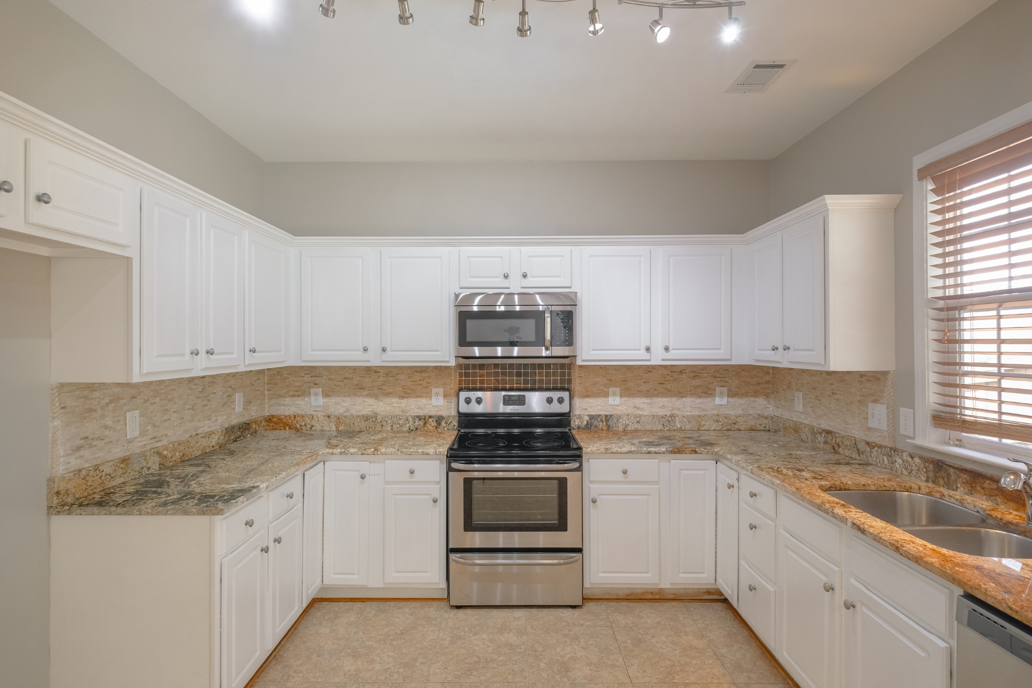 130 Stanwick Drive Franklin, TN 37067 - Photo 9 of 37 a kitchen with granite countertop white cabinets and appliances