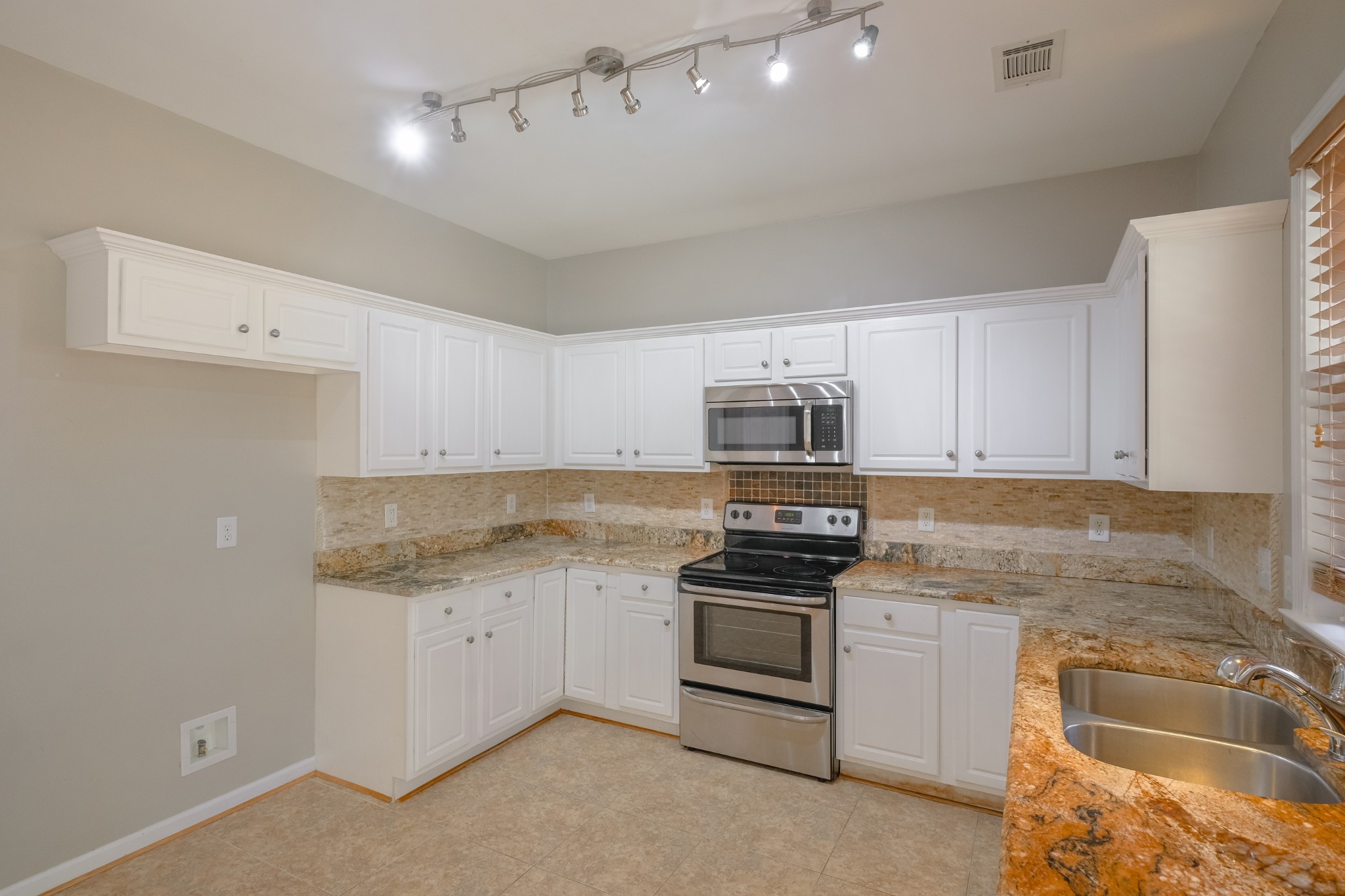 130 Stanwick Drive Franklin, TN 37067 - Photo 10 of 37 a kitchen with stainless steel appliances granite countertop a stove and a sink