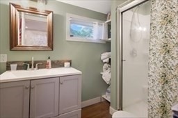 204 Elm Street Amesbury, MA 01913 - Photo 11 of 28 a bathroom with a sink and mirror with toilet