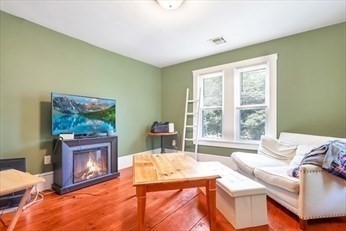 204 Elm Street Amesbury, MA 01913 - Photo 16 of 28 a living room with furniture and a fireplace