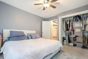 204 Elm Street Amesbury, MA 01913 - Photo 18 of 28 a bedroom with a bed and a chandelier