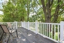 204 Elm Street Amesbury, MA 01913 - Photo 21 of 28 a balcony with wooden floor and fence