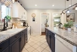 204 Elm Street Amesbury, MA 01913 - Photo 5 of 28 a kitchen with stainless steel appliances granite countertop a sink stove and cabinets