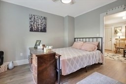 204 Elm Street Amesbury, MA 01913 - Photo 8 of 28 a bedroom with bed and paintings on the wall