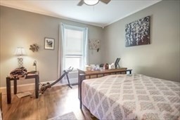 204 Elm Street Amesbury, MA 01913 - Photo 9 of 28 a bedroom with a bed and wooden floor