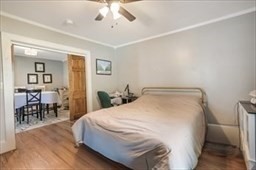 204 Elm Street Amesbury, MA 01913 - Photo 10 of 28 a spacious bedroom with a bed and a table in it