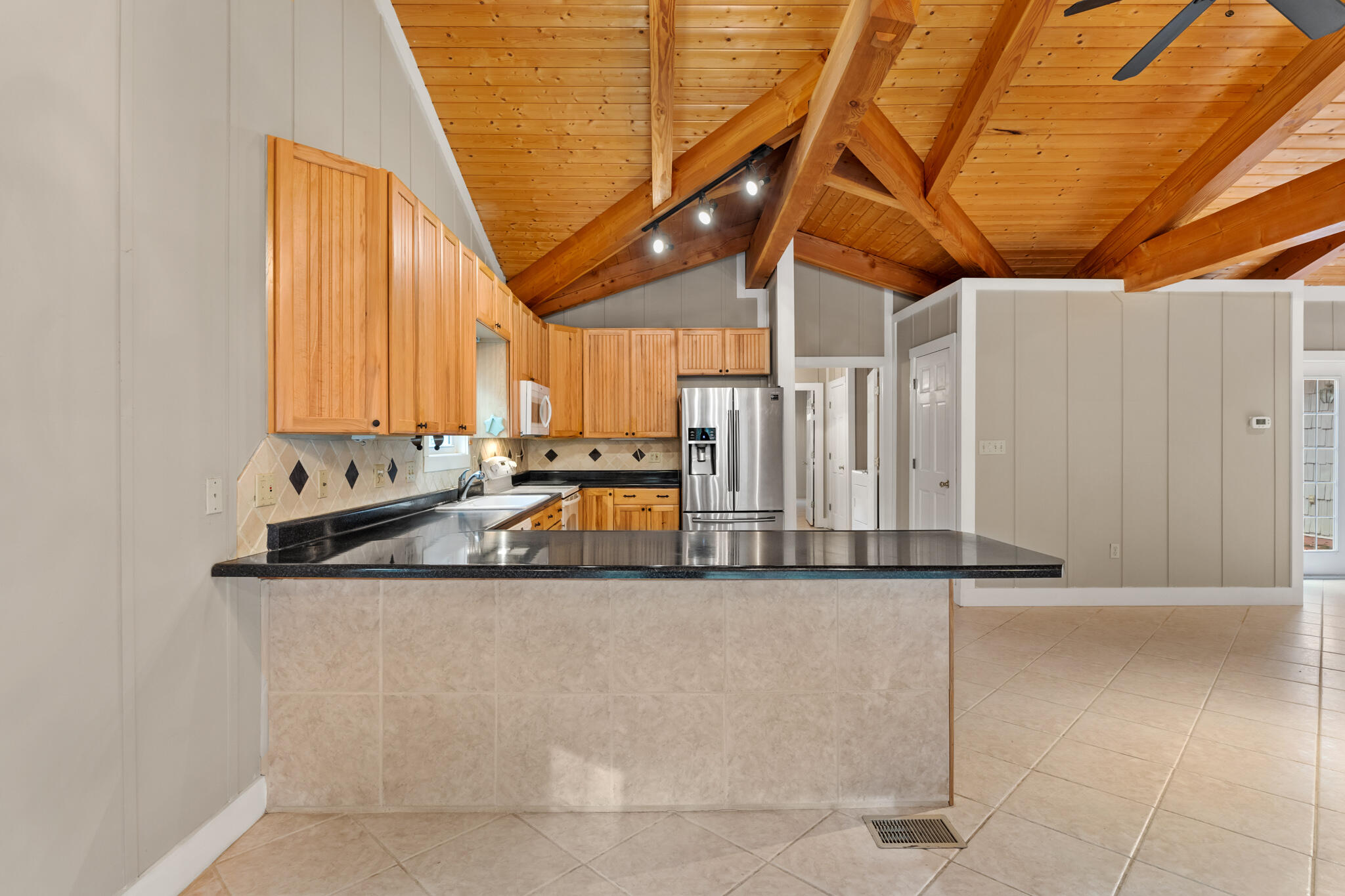 108 Osprey Lane Santa Rosa Beach, FL 32459 - Photo 8 of 40 a kitchen with stainless steel appliances granite countertop a sink and a white cabinets