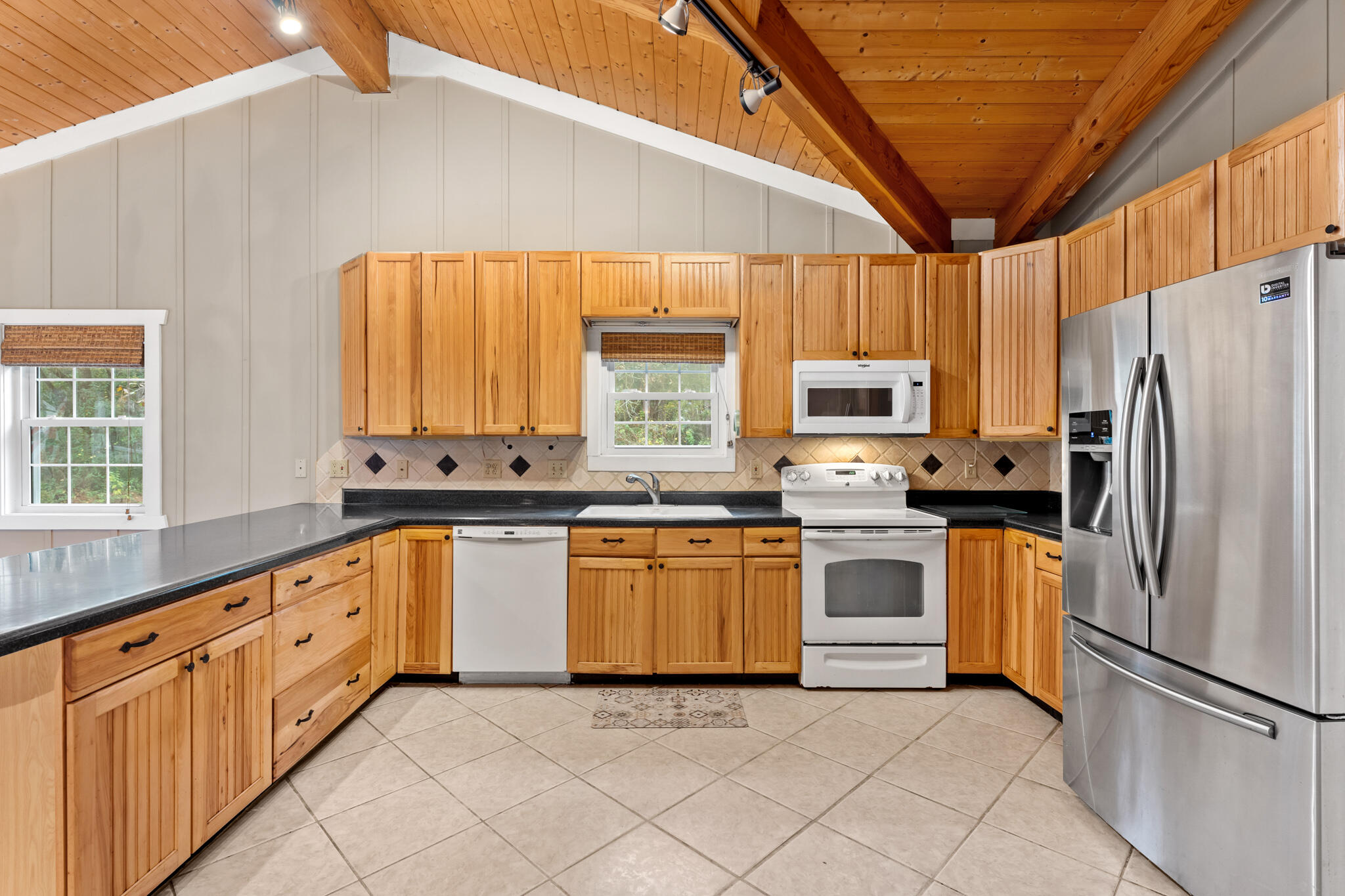 108 Osprey Lane Santa Rosa Beach, FL 32459 - Photo 9 of 40 a kitchen with granite countertop stainless steel appliances a refrigerator cabinets and a sink