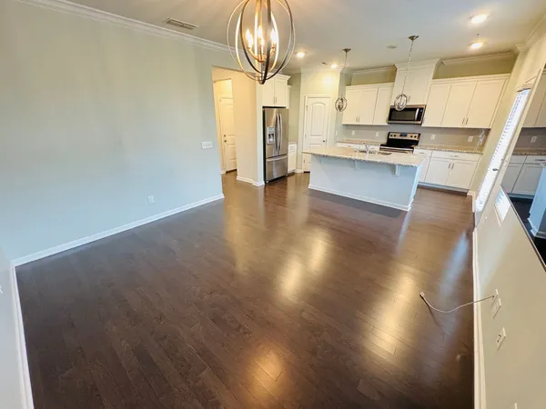a kitchen with stainless steel appliances a refrigerator and a stove top oven