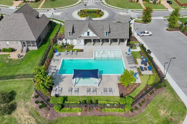 a view of a house with swimming pool and sitting area