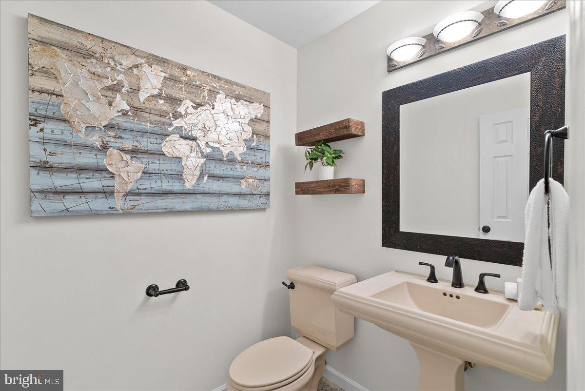 7596 Ruxton Drive Springfield, VA 22153 - Photo 12 of 40 a bathroom with a toilet sink and mirror