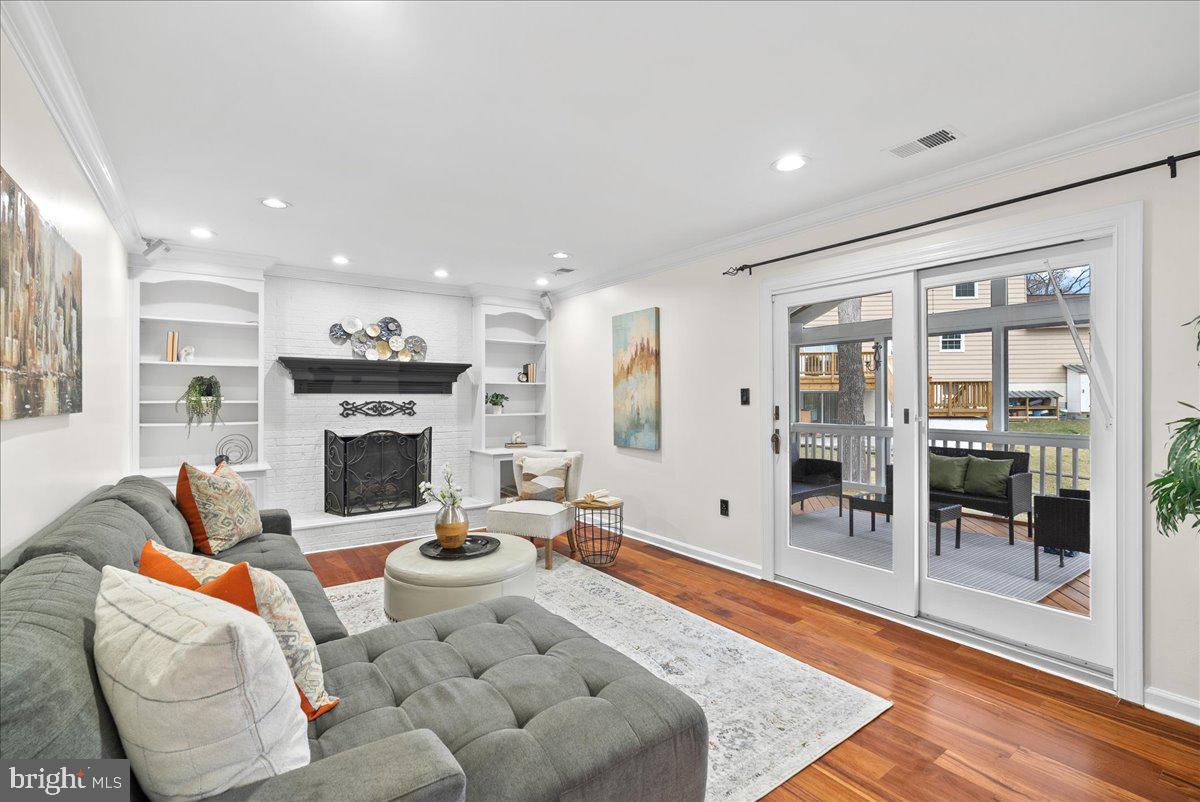 7596 Ruxton Drive Springfield, VA 22153 - Photo 15 of 40 a living room with furniture a fireplace and a view of kitchen
