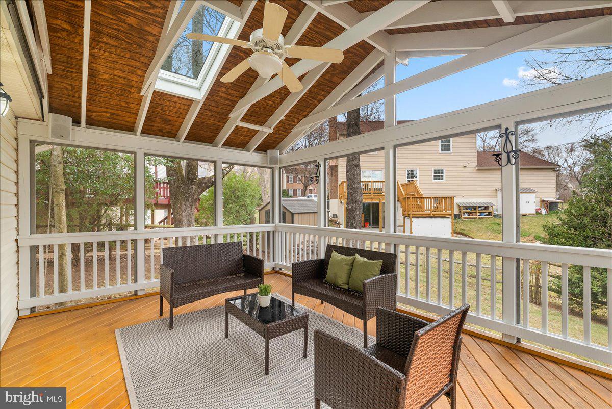 7596 Ruxton Drive Springfield, VA 22153 - Photo 17 of 40 a balcony with wooden benches and wooden floor