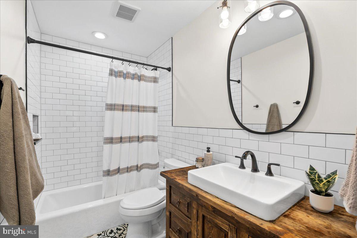 7596 Ruxton Drive Springfield, VA 22153 - Photo 29 of 40 a bathroom with a sink a toilet and a mirror
