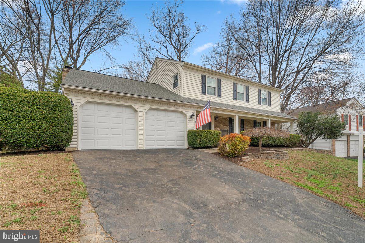 7596 Ruxton Drive Springfield, VA 22153 - Photo 39 of 40 a front view of a house with a yard and garage