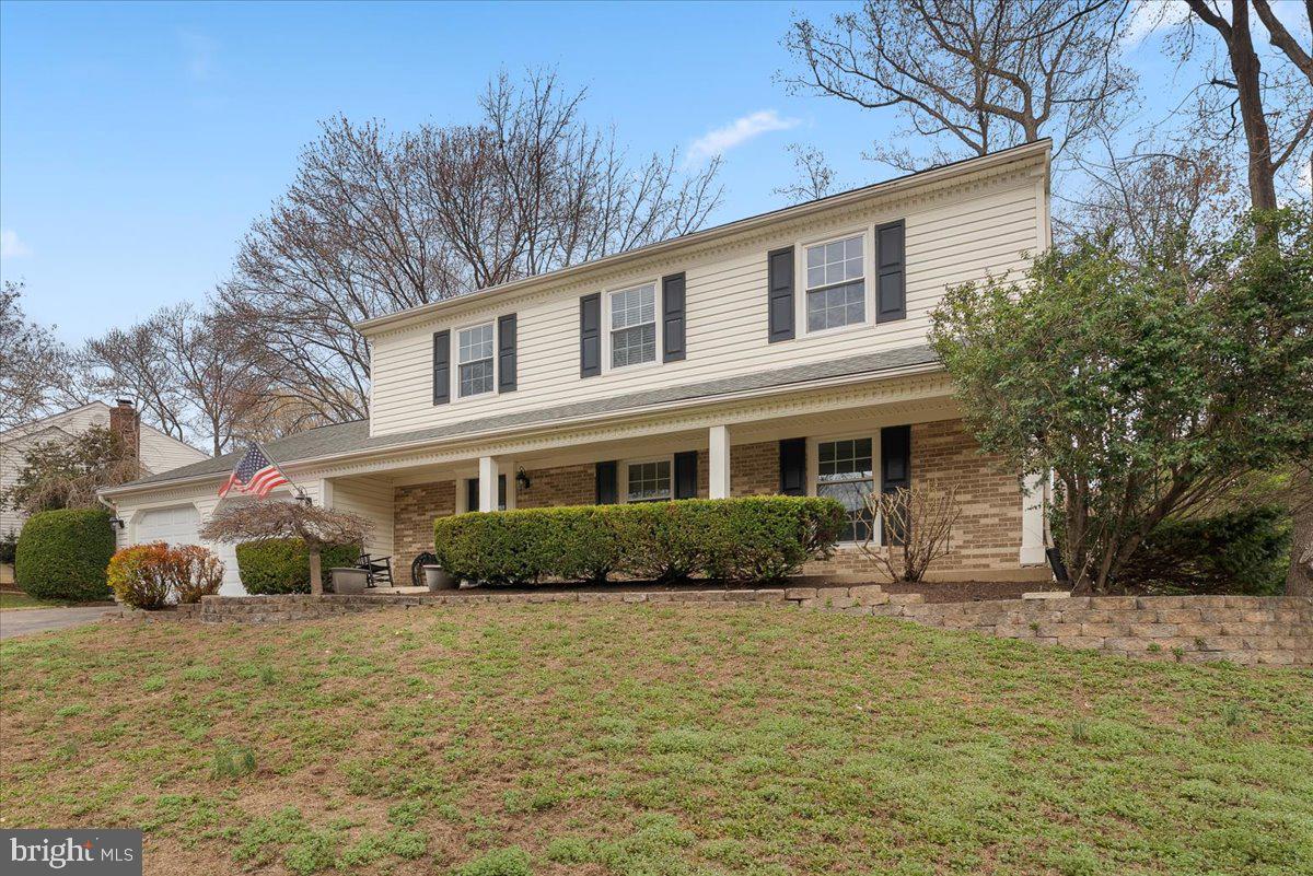 7596 Ruxton Drive Springfield, VA 22153 - Photo 40 of 40 a front view of a house with a yard and potted plants